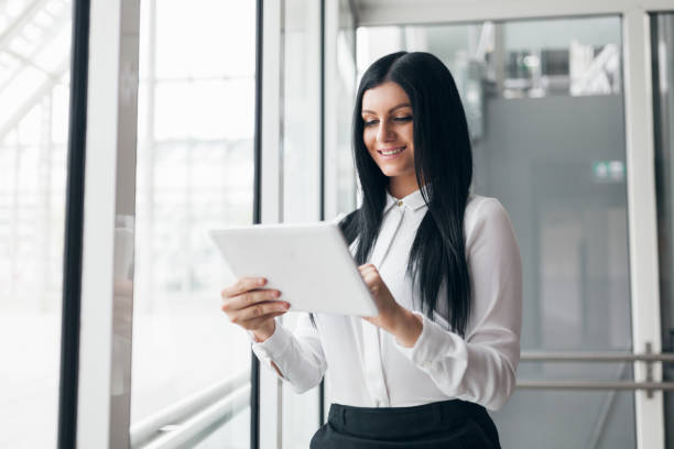 istock Successful confident business woman working with tablet in an office setting 858599920