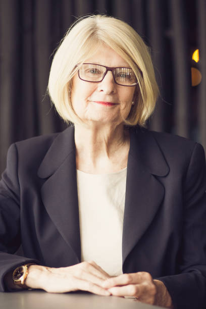istock Positive senior female executive sitting in office 858600372