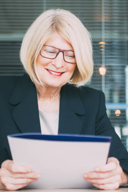 istock Positive senior HR worker holding personal file 858600450