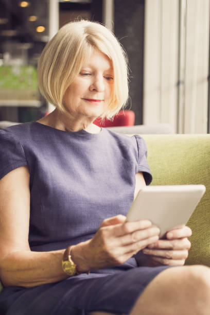istock Concentrated woman reading article on tablet 858600458