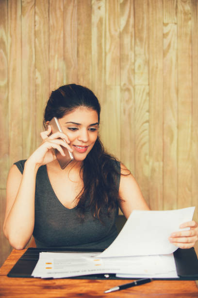 istock Smiling businesswoman talking on phone and working 858600658