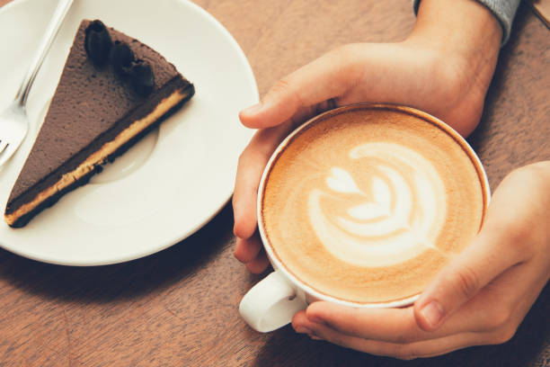 istock Woman drinking cappuccino and eating cake 858600704