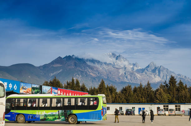 bus station in Lijiang to Jade Dragon Snow Mountain LIJIANG, CHINA - JAN 2: bus station in Lijiang to Jade Dragon Snow Mountain which  is a Moutain that is beautiful and world heritage city of China. on Jan 2, 2017 yunnan province stock pictures, royalty-free photos & images