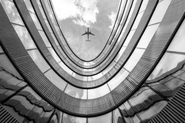 istock Flying airplane and modern architecture building 858610890