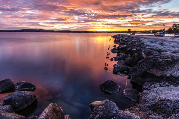 sunrise over the coast of lake michigan in traverse city michigan - water lake reflection tranquil scene imagens e fotografias de stock