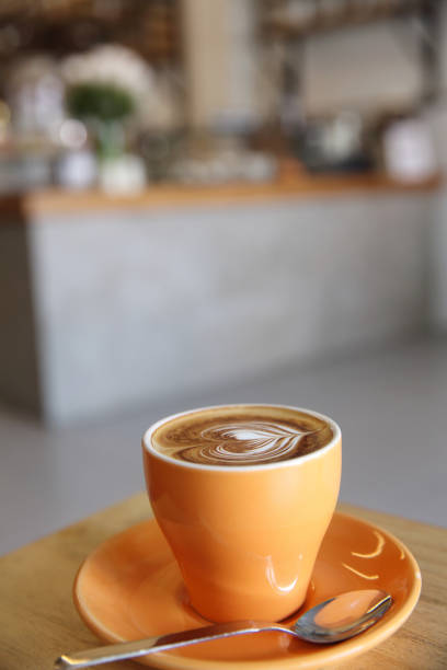 istock cappuccino coffee on wood background 858611766