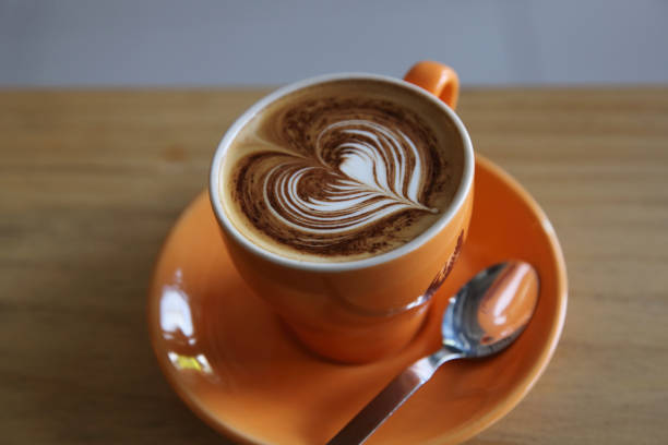 istock cappuccino coffee on wood background 858612274