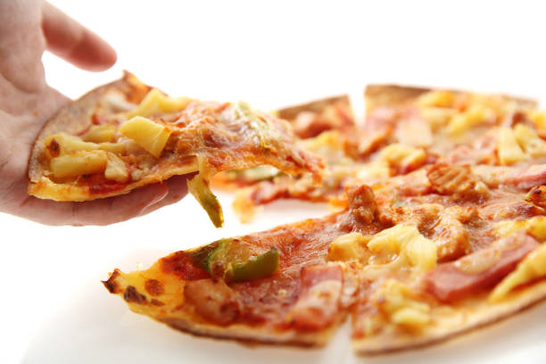istock pizza , chicken green pepper pineapple on hand isolated in white background 858614664