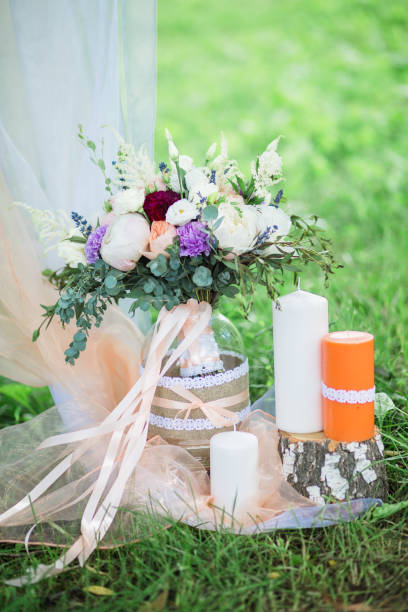 istock Wedding bouquet with candles on green grass 858614942
