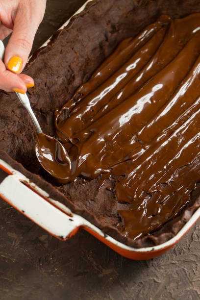 istock Hot chocolate is applied to the dough in a baking dish 858621940