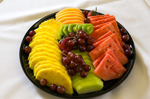 A fruit tray with watermelon and pineapples