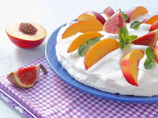 Meringue cake. Traditional Pavlova dessert with fruits. stock photo