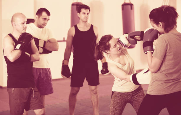 istock Sportswomen competing in colored boxing gloves 858626478