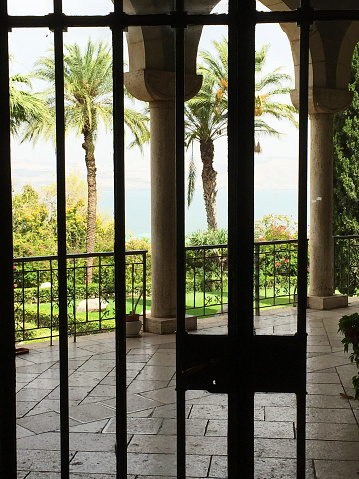 on the mount of Beatitudes in Israel. View from inside the church through a gate in the wunderful garden