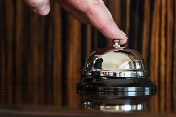 istock hand presses the service bell on reception in hotel 858630020