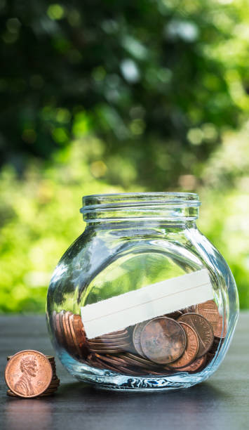 istock one cent coins in a glass jar on the table in a garden 858630184