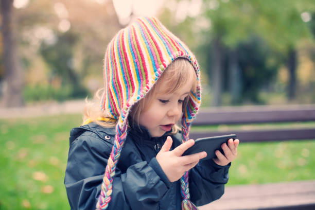 istock Little child with smart phone 858630480