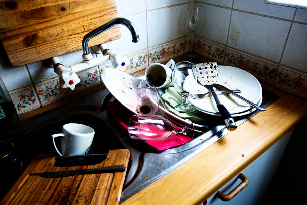 istock Kitchen sink with unwashed dirty dished piled high 858630664