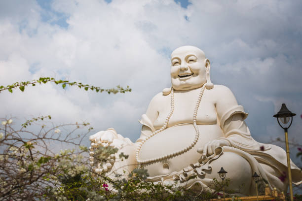 My Tho, Vietnam - January 03, 2016: Statue of Budai, a Chinese folkloric deity nicknamed Laughing Buddha, at the Vinh Trang Temple on the city of My Tho, Vietnam.