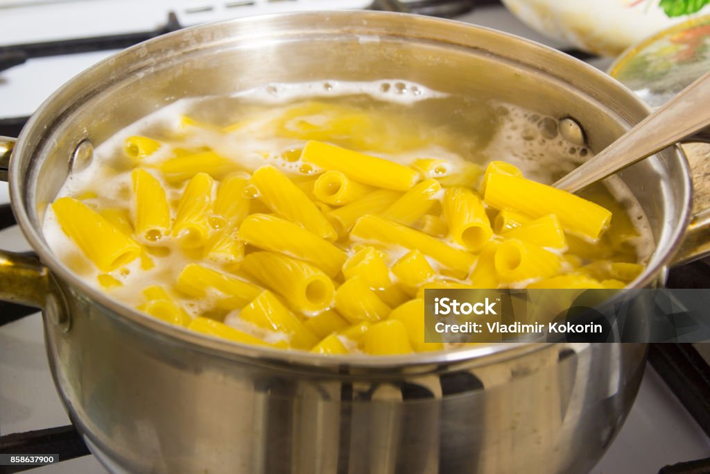 Cooking pasta at home. Italian pasta cooked in salted water. Pasta Stock Photo