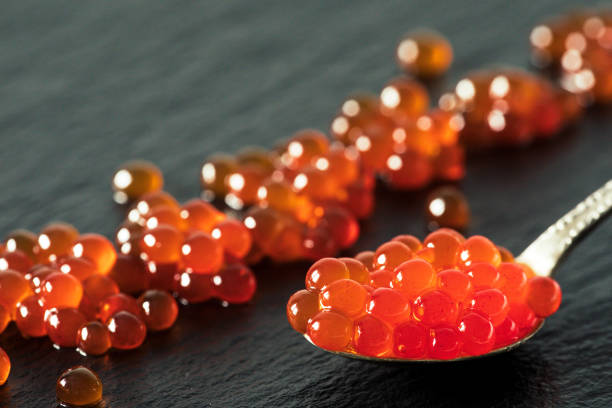 istock red caviar in a spoon on a black slate background 858637930