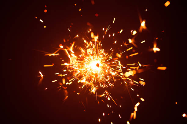 istock Christmas sparkler in haze with red light 858643128