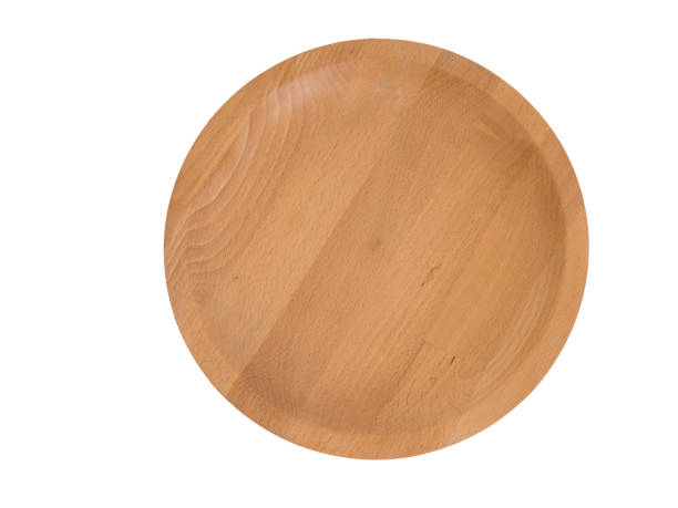 istock Round wooden plate or tray crafted by hand isolated on white. 858645896