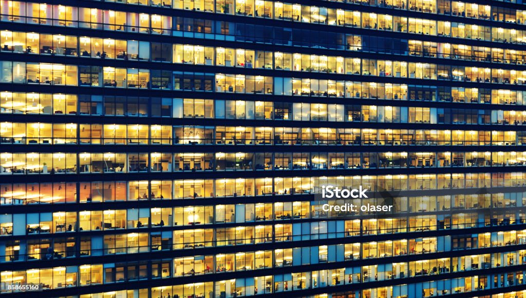 Office workers working late in major office building Crowded Stock Photo