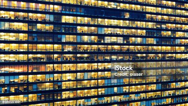 Office Workers Working Late In Major Office Building Stock Photo - Download Image Now