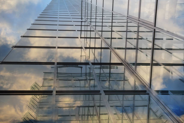 istock Steel and glass finance building, reflecting clouds 858655818
