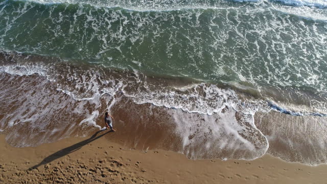 High angle view of man walking on the beach