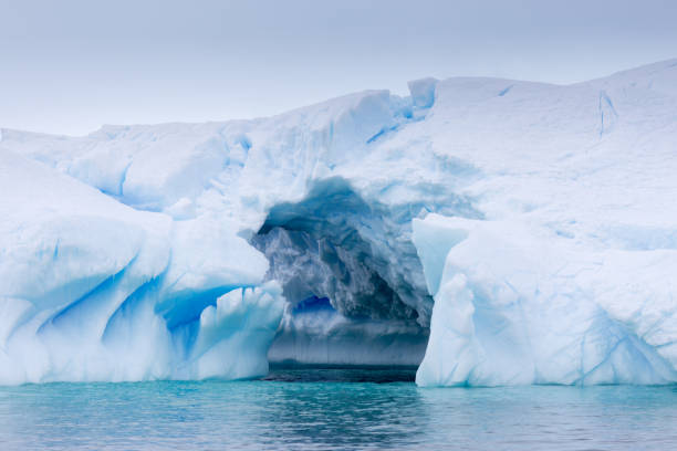 istock A huge cave has been carved in tho this iceberg. 858662678
