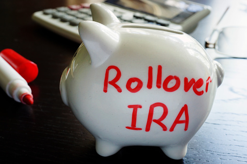 Rollover IRA written on a piggy bank.