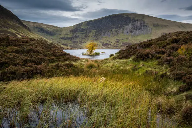 A remote mountain loch in the Scottish Borders the outflow from the loch become the famous waterfall The Grey Mares Tail