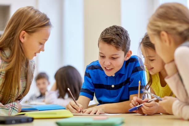 istock group of students talking and writing at school 858670550
