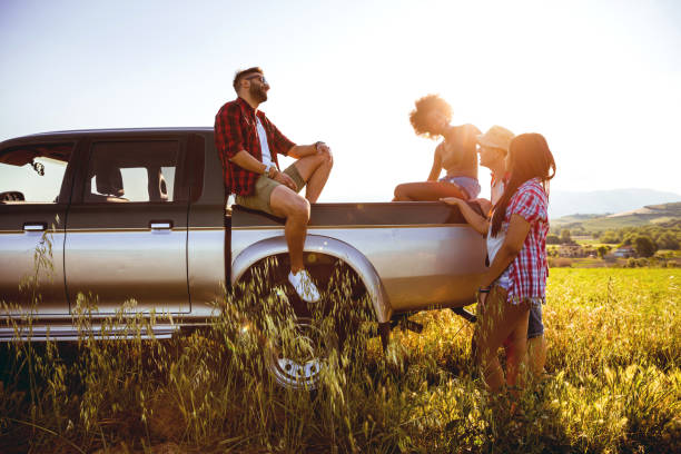 Young friends enjoying the freedom on a Car Trip over a country offroad