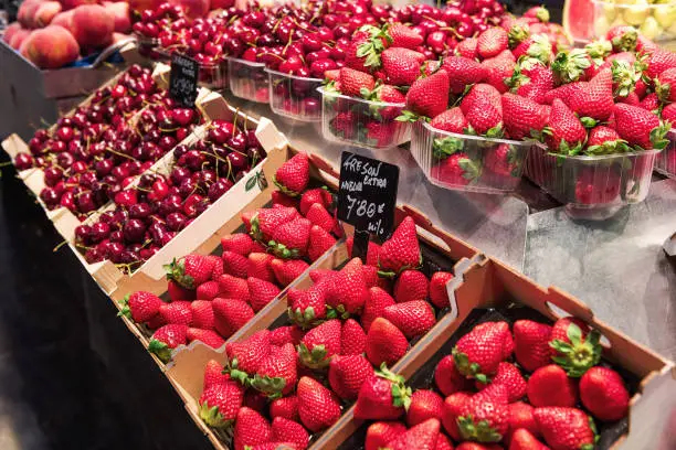Red Strawberries with cherry in La Boqueria Food Market, Barcelona, Spain.