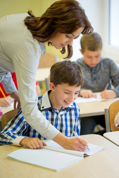 istock group of school kids writing test in classroom 858672004