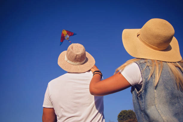 istock Young couple flying kite 858674644