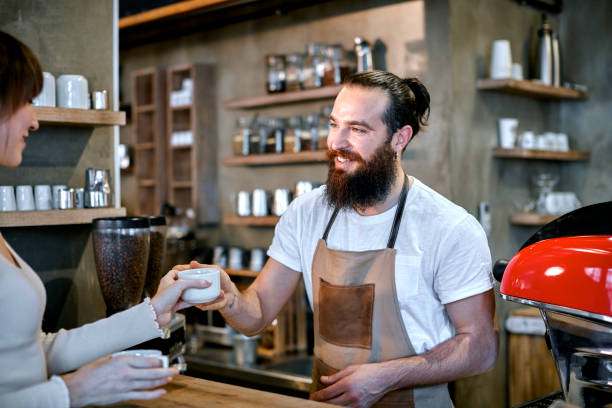 istock Staff Serving Customer In Busy Coffee Shop 858674830