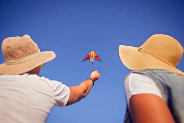 istock Beautiful couple flying kite 858675028
