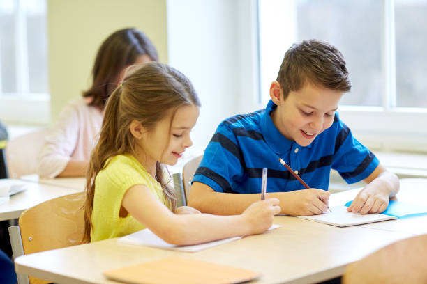 istock group of school kids writing test in classroom 858675146