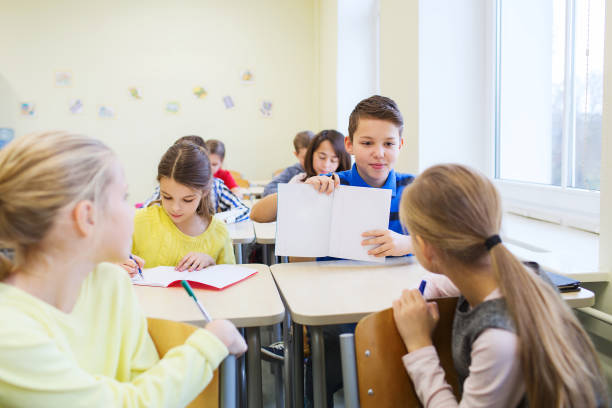 istock group of school kids writing test in classroom 858675376