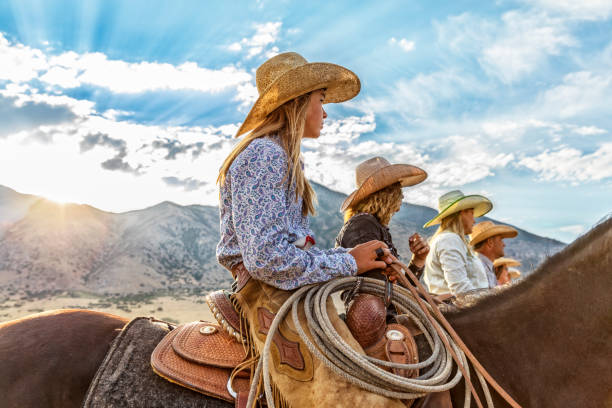 Cowgirls and Cowboy line up waiting to go for a ride in the morning Cowgirls and Cowboy line up waiting to go for a ride in the morning cowgirl stock pictures, royalty-free photos & images