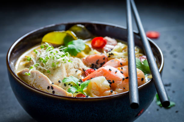 istock Yummy Malaysian Soup with chicken and shrimps 858679072