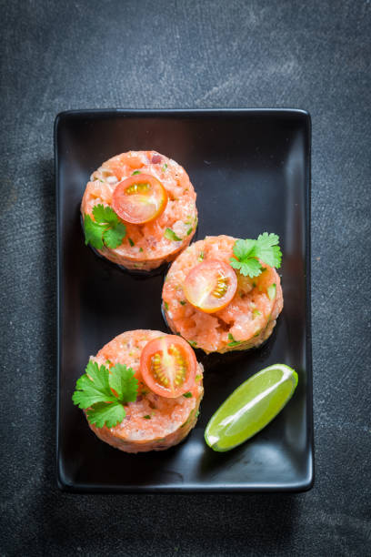 istock Tasty salmon tartare with lime and cherry tomatoes 858688088