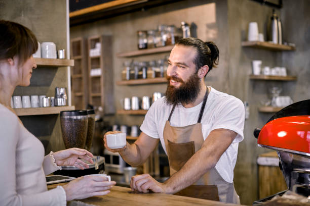 istock Staff Serving Customer In Busy Coffee Shop 858688178