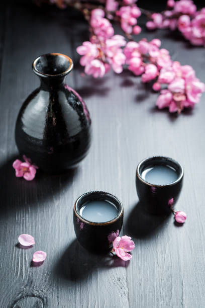 istock Unfiltered white sake sake with blooming flowers 858694528
