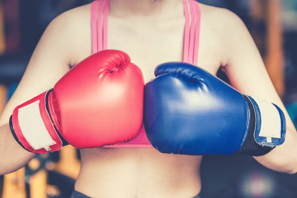 istock Attractive Female Punching A Bag With Boxing Gloves 858695956
