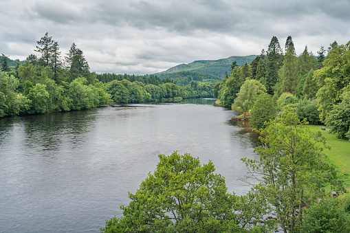 Landscape stock photograph of River Tay and lush forests, Scotland, UK.